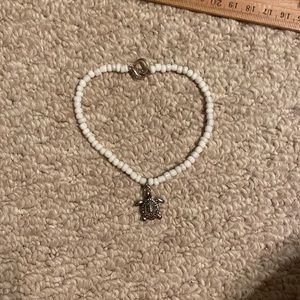 white anklet with a turtle